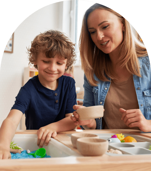 Child and adult playing with sensory toys.
