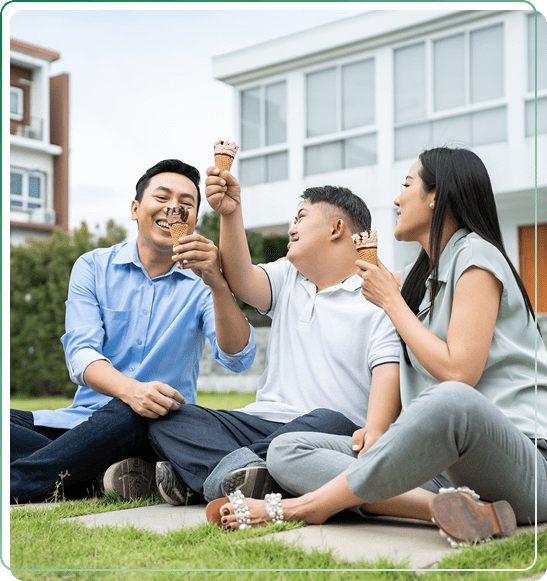 Three friends enjoying ice cream outdoors.